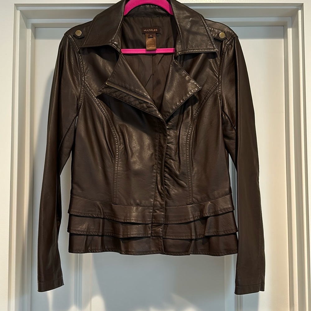 Brown motorcycle-style jacket. Zip up. Ruffle detail at the bottom.